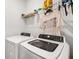 Efficient laundry room with modern appliances and convenient shelving at 5000 Paddy Field Way, Ladson, SC 29456