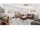 Large living room with plush seating, stylish rug, and big windows for natural light at 5000 Paddy Field Way, Ladson, SC 29456