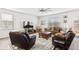 Bright living room featuring plush seating, large windows, and modern ceiling fan at 5000 Paddy Field Way, Ladson, SC 29456