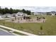 Community playground with swings, slide, and picnic area surrounded by residential homes at 5000 Paddy Field Way, Ladson, SC 29456