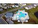 Aerial view of a modern community pool with lounge chairs, umbrellas, and clubhouse at 5000 Paddy Field Way, Ladson, SC 29456