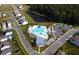 Aerial view of modern community pool, lush landscaping, and surrounding neighborhood homes at 5000 Paddy Field Way, Ladson, SC 29456