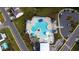 Aerial view of a community pool with lounge chairs, umbrellas, and lush landscaping near a parking lot at 5000 Paddy Field Way, Ladson, SC 29456