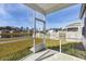 Relaxing screened porch overlooking a lush lawn, tranquil pond, and neighborhood homes at 5000 Paddy Field Way, Ladson, SC 29456