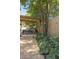 The backyard features a covered patio, gravel landscaping, wooden privacy fence and mature landscaping at 5010 Converse St, North Charleston, SC 29405