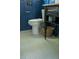 Bathroom with white penny tile flooring and dark blue wainscoting with a basket at 5010 Converse St, North Charleston, SC 29405