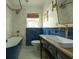 This bathroom is designed with blue paneling, and modern fixtures and is brightly lit at 5010 Converse St, North Charleston, SC 29405