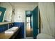 This modern bathroom has blue paneling, a stylish sink, and great storage space at 5010 Converse St, North Charleston, SC 29405