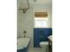 This bathroom features a blue paneled door, a modern tub, and bright lighting at 5010 Converse St, North Charleston, SC 29405
