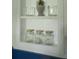 This bathroom features sleek shelves with decorations, white walls, and blue paneling at 5010 Converse St, North Charleston, SC 29405
