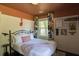 Comfortable bedroom features a bed with soft white linens, colorful curtains, and quirky decor at 5010 Converse St, North Charleston, SC 29405