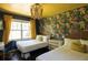 Charming bedroom with bright floral wallpaper, two beds, desk, and stylish overhead lighting at 5010 Converse St, North Charleston, SC 29405