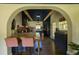 Eat-in kitchen features an arched entry, wooden beams, and modern appliances at 5010 Converse St, North Charleston, SC 29405