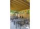 Pergola with a dining table, lounge chairs, and hammocks for outdoor relaxation at 5010 Converse St, North Charleston, SC 29405