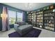 Stylish bedroom with a bookcase wall, chaise lounge, purple rug, and chandelier at 505 Spanish Wells Road Rd, Summerville, SC 29486