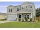 Two story home boasting a well manicured lawn, two car garage, and stylish craftsman architectural details at 505 Spanish Wells Road Rd, Summerville, SC 29486