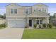 Two story home featuring manicured lawn, two car garage, craftsman architecture, and a welcoming front porch at 505 Spanish Wells Road Rd, Summerville, SC 29486