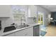 Bright kitchen with stainless steel sink, granite counters, and view to a manicured backyard at 505 Spanish Wells Road Rd, Summerville, SC 29486