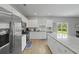 Well-lit kitchen with stainless steel appliances, granite countertops, and a view of the backyard at 505 Spanish Wells Road Rd, Summerville, SC 29486