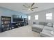 Cozy living room with a ceiling fan, television, bookshelves, and a grey L-shaped couch at 505 Spanish Wells Road Rd, Summerville, SC 29486