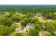 A neighborhood aerial view showing lush trees and a home with a pool at 518 Woodward Blvd, Summerville, SC 29483
