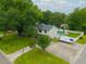 Aerial view of a home featuring a private pool, fenced yard, mature landscaping, and driveway with covered boat at 518 Woodward Blvd, Summerville, SC 29483