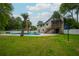Backyard with a pool, a covered deck, a privacy fence and green grass at 518 Woodward Blvd, Summerville, SC 29483