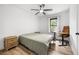 Bright bedroom features a ceiling fan, natural light, light wood floors, side table and desk at 518 Woodward Blvd, Summerville, SC 29483