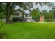 Traditional two-story home with lush green lawn, mature trees, and a brick feature at 518 Woodward Blvd, Summerville, SC 29483