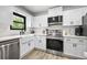 Bright white kitchen features stainless steel appliances, white subway tile, and a farmhouse sink at 518 Woodward Blvd, Summerville, SC 29483