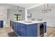 Kitchen island with white countertop, seating, stainless beverage cooler, and blue cabinets at 518 Woodward Blvd, Summerville, SC 29483
