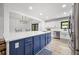 Modern kitchen with white cabinets, stainless appliances, and a blue island with white countertop at 518 Woodward Blvd, Summerville, SC 29483