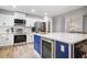 Spacious open concept kitchen with a blue island and stainless steel appliances at 518 Woodward Blvd, Summerville, SC 29483