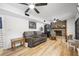 Bright living room with ceiling fans, a fireplace, wood floors, a couch and arm chairs at 518 Woodward Blvd, Summerville, SC 29483