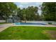 Backyard with a pool, inflatable floats, privacy fence, and a small outbuilding at 518 Woodward Blvd, Summerville, SC 29483