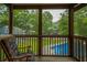 View from screened porch featuring a pool, chairs and surrounding greenery at 518 Woodward Blvd, Summerville, SC 29483