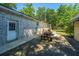 Backyard patio area featuring outdoor seating, lush lawn, and mature trees at 5302 Helene Dr, North Charleston, SC 29418
