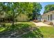 Spacious backyard featuring patio seating, lush lawn, and mature trees at 5302 Helene Dr, North Charleston, SC 29418