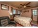 Cozy bedroom featuring a ceiling fan, hardwood floors, and a comfortable seating area at 5302 Helene Dr, North Charleston, SC 29418