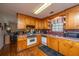 A bright kitchen featuring wooden cabinets, updated appliances and a charming, vintage aesthetic at 5302 Helene Dr, North Charleston, SC 29418