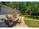 Features an outdoor patio setup with a dining set under a shaded area in the yard at 5302 Helene Dr, North Charleston, SC 29418