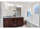 Bright bathroom featuring double vanity with granite countertop and a soaking tub at 536 Man O War Ln, Moncks Corner, SC 29461