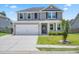 Charming two-story home with gray siding, well-manicured lawn, and a spacious two car attached garage at 536 Man O War Ln, Moncks Corner, SC 29461