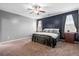 Comfortable main bedroom with plush carpet, ceiling fan, and ensuite bathroom at 536 Man O War Ln, Moncks Corner, SC 29461