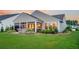 Backyard view showcasing the patio with stone, with lush landscaping at 554 Tidewater Chase Ln, Summerville, SC 29486
