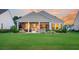 An eye-level shot of backyard of the house, featuring a patio with stone and lush landscaping at 554 Tidewater Chase Ln, Summerville, SC 29486