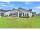 Beautiful backyard featuring a covered patio with stone accents and lush landscaping at 554 Tidewater Chase Ln, Summerville, SC 29486