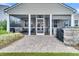 Backyard patio with screened-in porch, outdoor kitchen, and manicured landscaping at 554 Tidewater Chase Ln, Summerville, SC 29486
