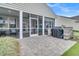 View of backyard patio and screened-in porch with outdoor kitchen and lounge area at 554 Tidewater Chase Ln, Summerville, SC 29486