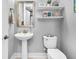 Bathroom showcasing a pedestal sink, toilet, floating shelves, and neutral decor at 554 Tidewater Chase Ln, Summerville, SC 29486